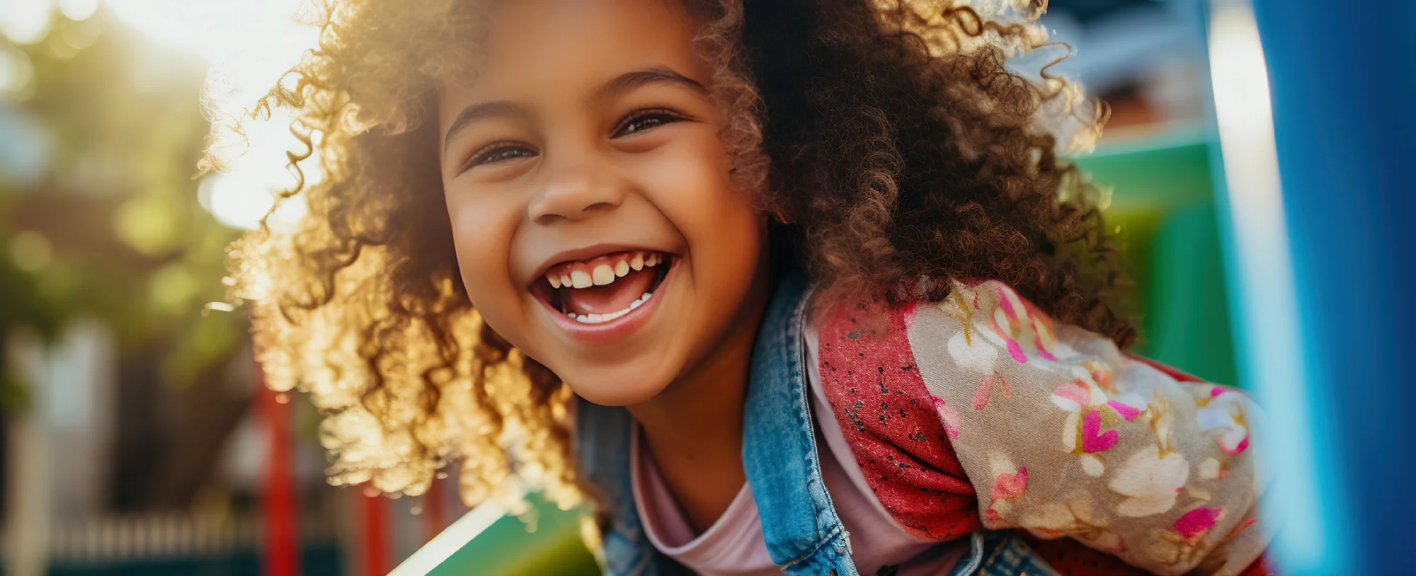 Smiling young girl outdoors representing family, hope, and healing through accessible mental health support at HARTT Counseling and Wellness.